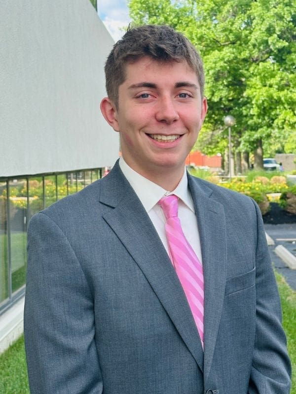 A photo of Kolton Kohler wearing a white dress hirt, pink tie and gray suit.